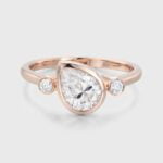 Unique Three Stone Bezel Pear Shaped Moissanite Promise Ring In 14K Rose Gold