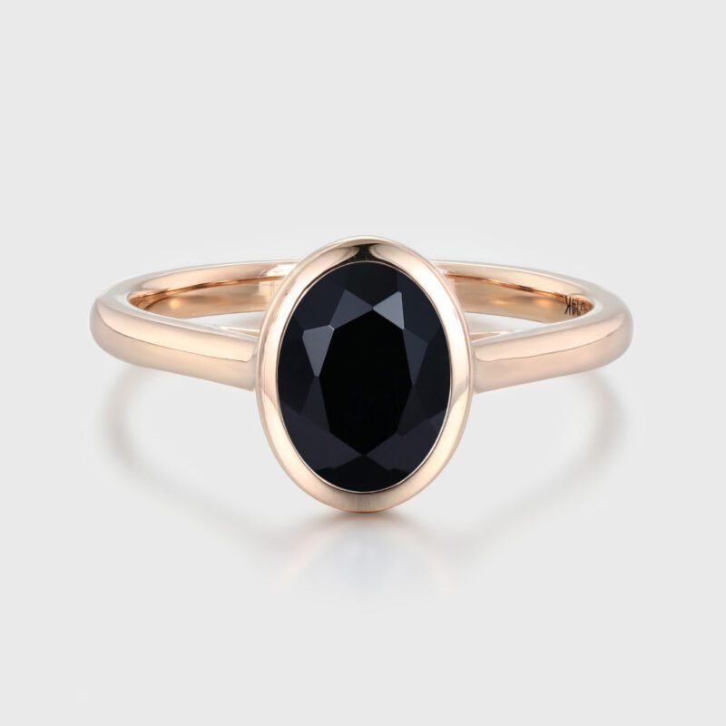 Simplicity meets elegance in our Oval Cut Solitaire Bezel Black Onyx Engagement Ring. It's a timeless symbol of love and beauty.