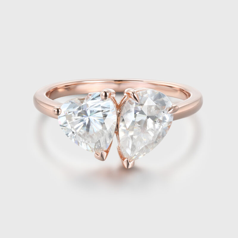 Heart shaped and pear cut lab-grown diamond engagement ring in 14K rose gold, featuring a two-stone Toi et Moi design, perfect for engagements and anniversaries.